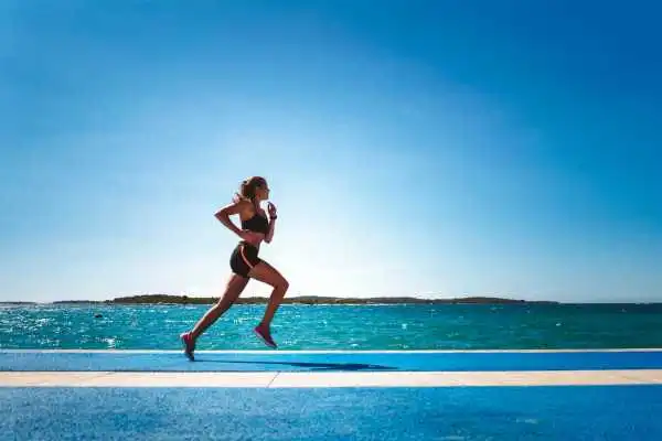 Woman running showing strong leg muscle Northampton